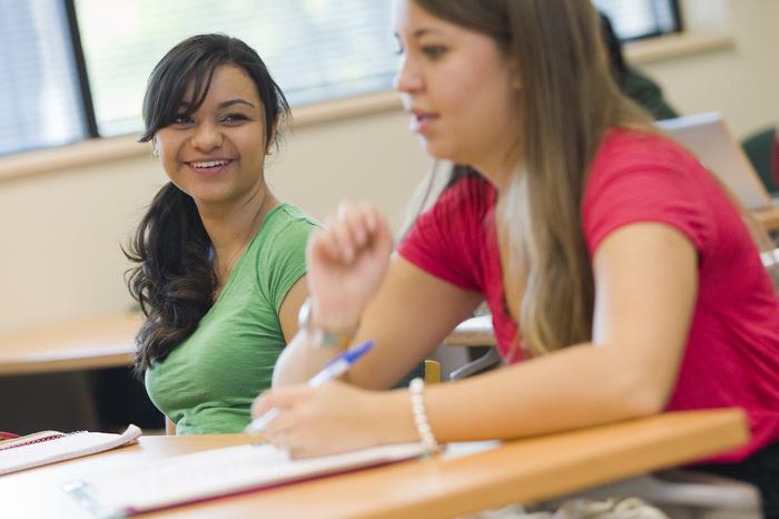 Students engaged in a discussion in a classroom.